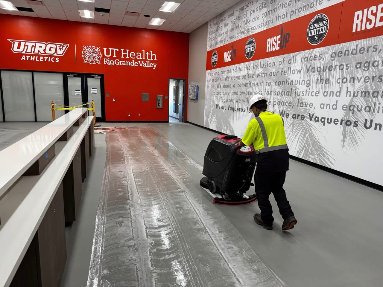 One Stop Janitorial staff operating commercial floor cleaning machine