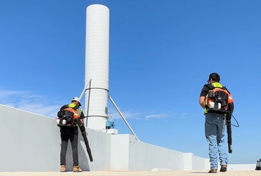 One Stop crew clearing a rooftop with backpack blowers