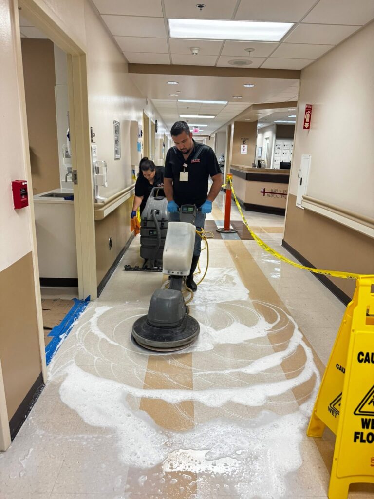One Stop crew stripping and waxing a hospital hallway floor
