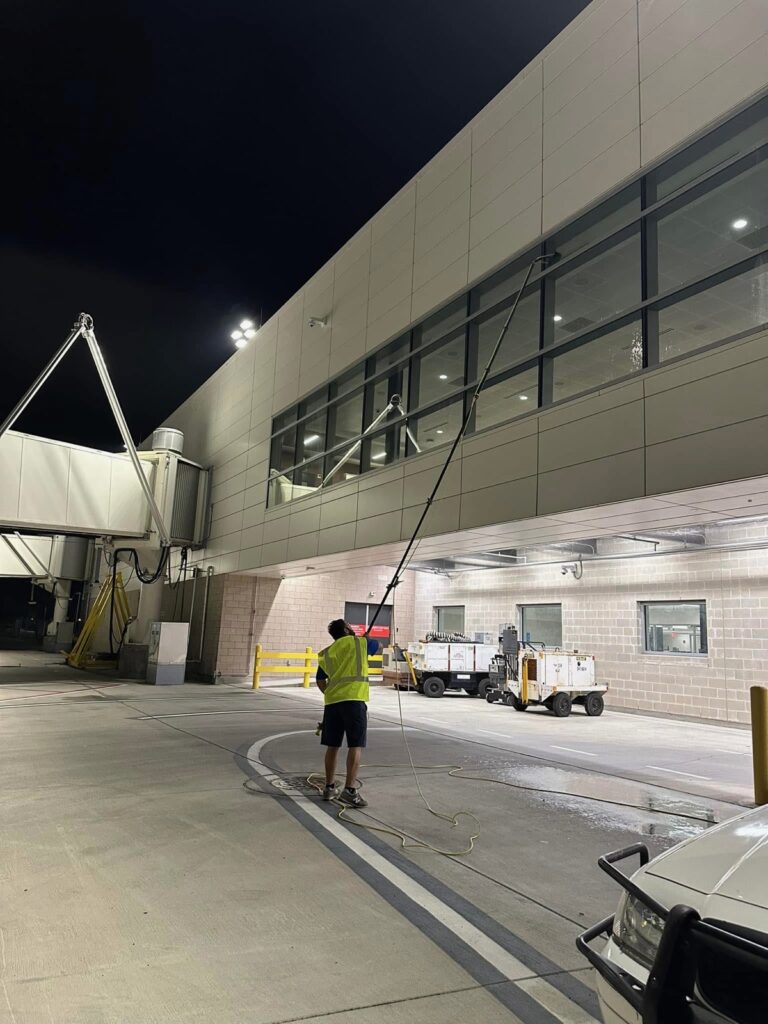One Stop crew cleaning exterior windows at night